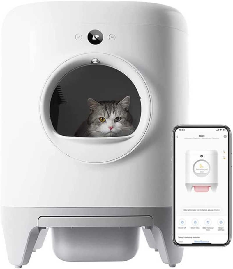 This poster showcases the PETKIT Pura X Self-Cleaning Automatic Cat Litter Box, the Image shows a Cute White/Black cat with Yellow/Black eyes sitting calmly inside the unit and looking out from the entrance window, Along side this unit the product's image is also shown on a mobile screen while operating the unit using the supported app for this product.
