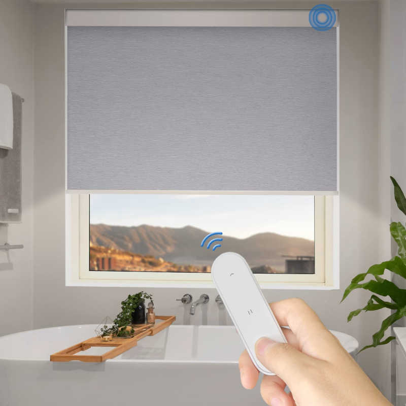 This poster showcases the Automatic Windows Blinds of light Gray color being operated using a a remote control pointed towards the sensor on the Automatic Windows Blinds Unit.